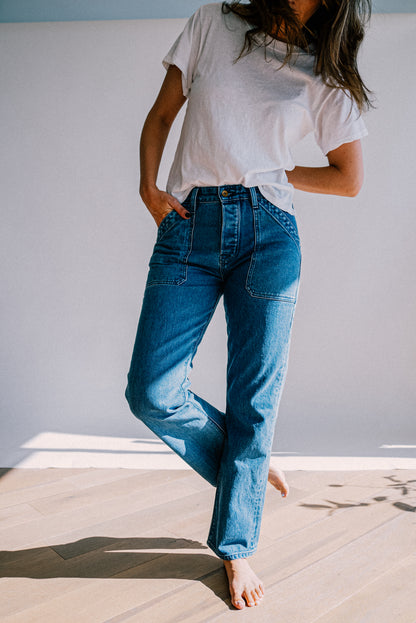 Women’s light blue designer denim jeans, featuring a high rise fit, straight leg cut, and structured front seams for a refined yet casual style