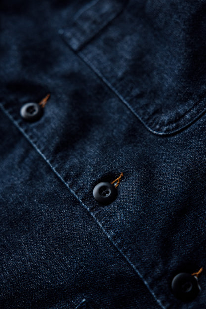 Close-up of the Scout denim chore blazer in ocean blue, showing dark buttons and tobacco keyhole stitching.