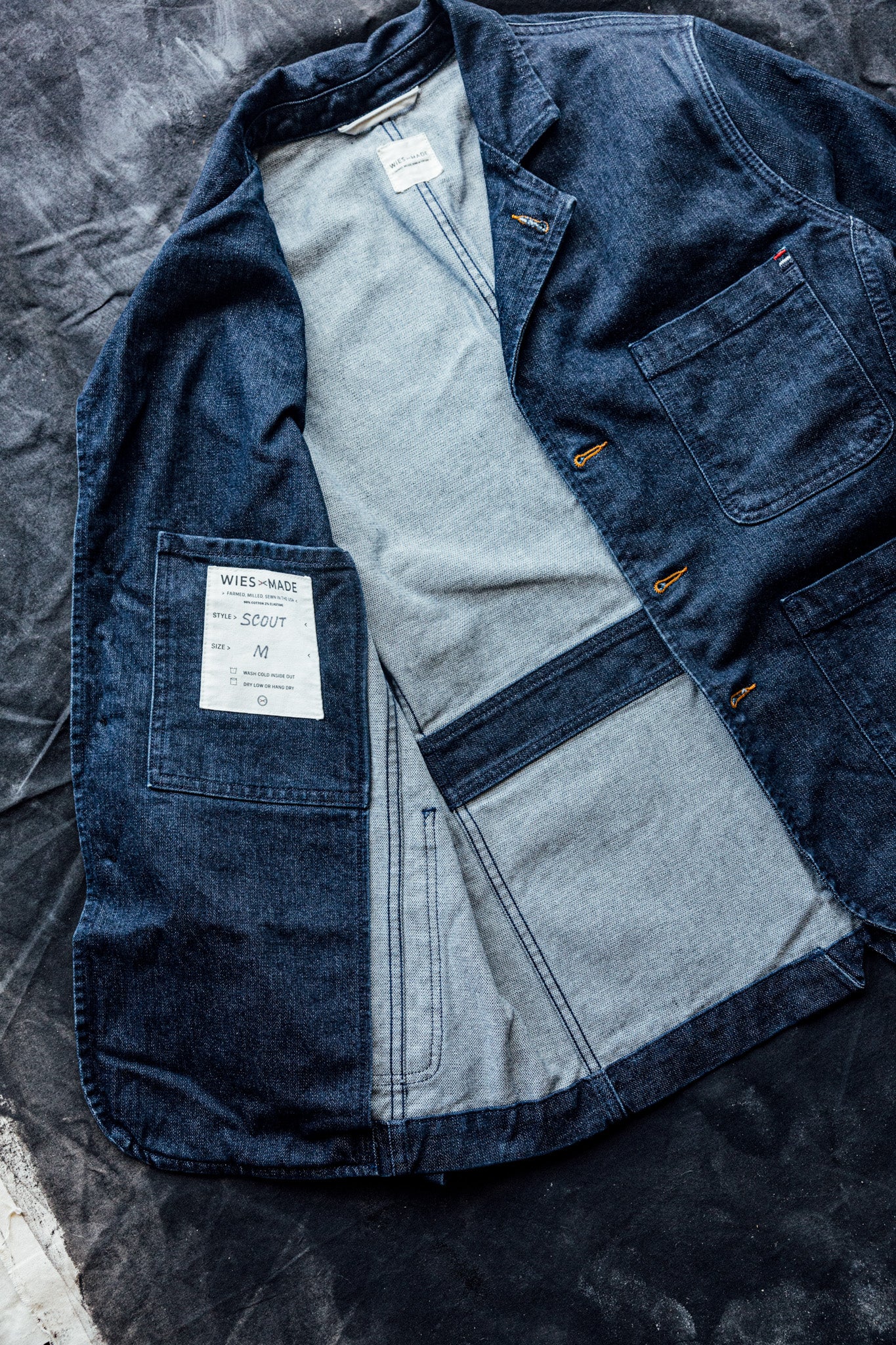 Scout denim chore blazer laid open to show interior pocket, raw selvedge seams, and size M label.