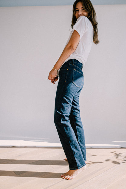 Side view of high-rise straight-leg ocean wash American made jeans paired with a white tee.