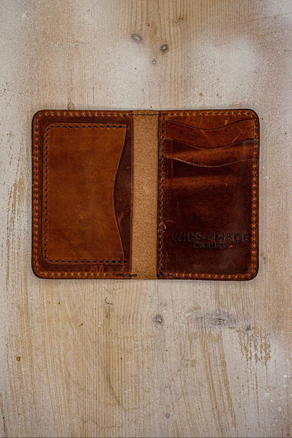 Open tan Horween leather bifold wallet showing card slots and WiesMade Made in USA stamp.