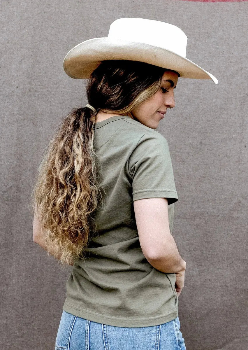 Back view of olive heavyweight cotton tee paired with a cowboy hat and blue jeans.
