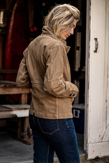 Back view of wheat denim chore blazer showing elbow patches, cuff buttons, and flat-felled seams.