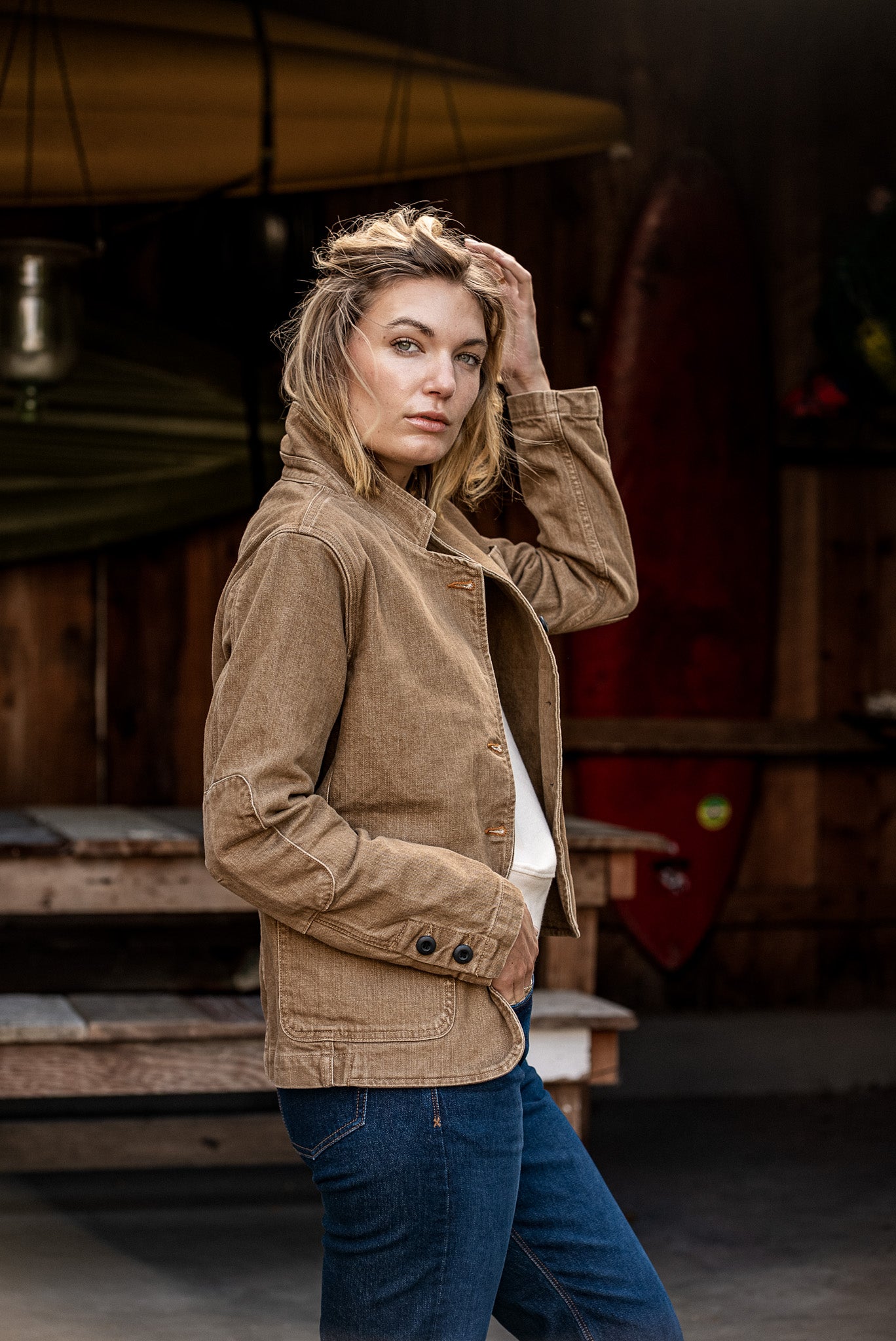 Wheat women's denim chore blazer worn on-model, side view showing cuff buttons and patch pocket.