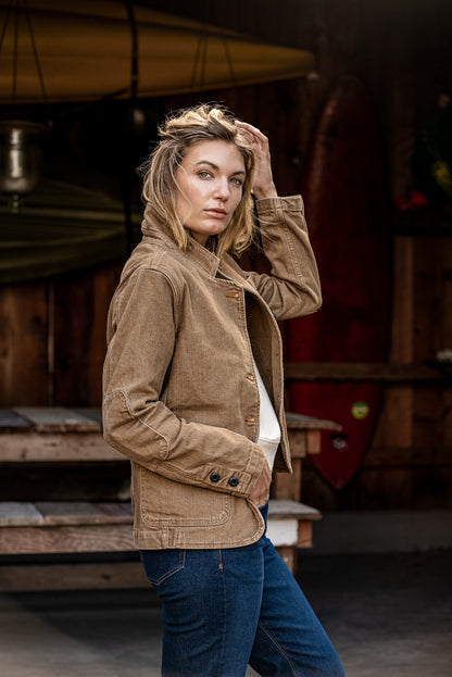 Wheat women's denim chore blazer worn on-model, side view showing cuff buttons and patch pocket.