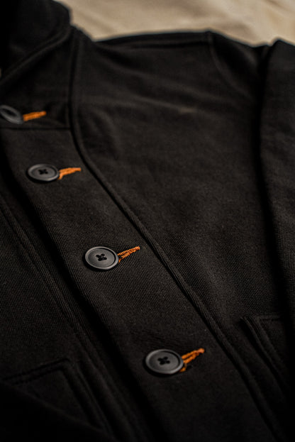 Close-up of the Bodega shawl cardigan in basalt black French terry with tobacco-thread keyhole buttonholes.