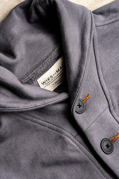 Close-up of pebble grey French terry cardigan showing shawl collar, WiesMade label, and tobacco-stitched keyhole buttons.