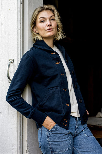Navy French terry cardigan worn open over cream tee with contrast tobacco keyhole buttons.