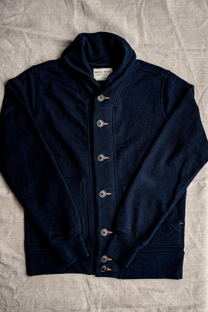 Navy shawl-collar Bodega cardigan in cotton French terry, buttoned flat-lay on linen.