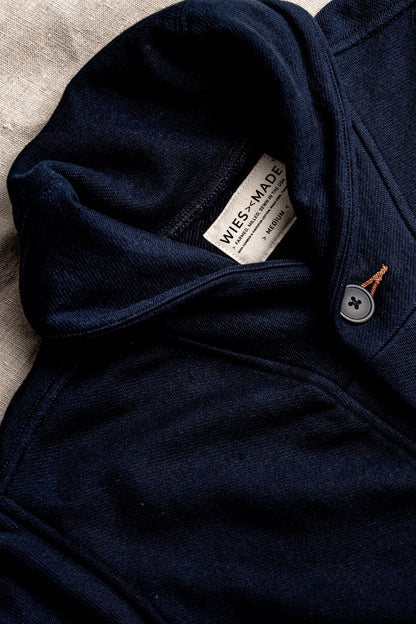 Navy French terry Bodega cardigan detail: shawl collar, WiesMade label, grey button, tobacco keyhole stitch.