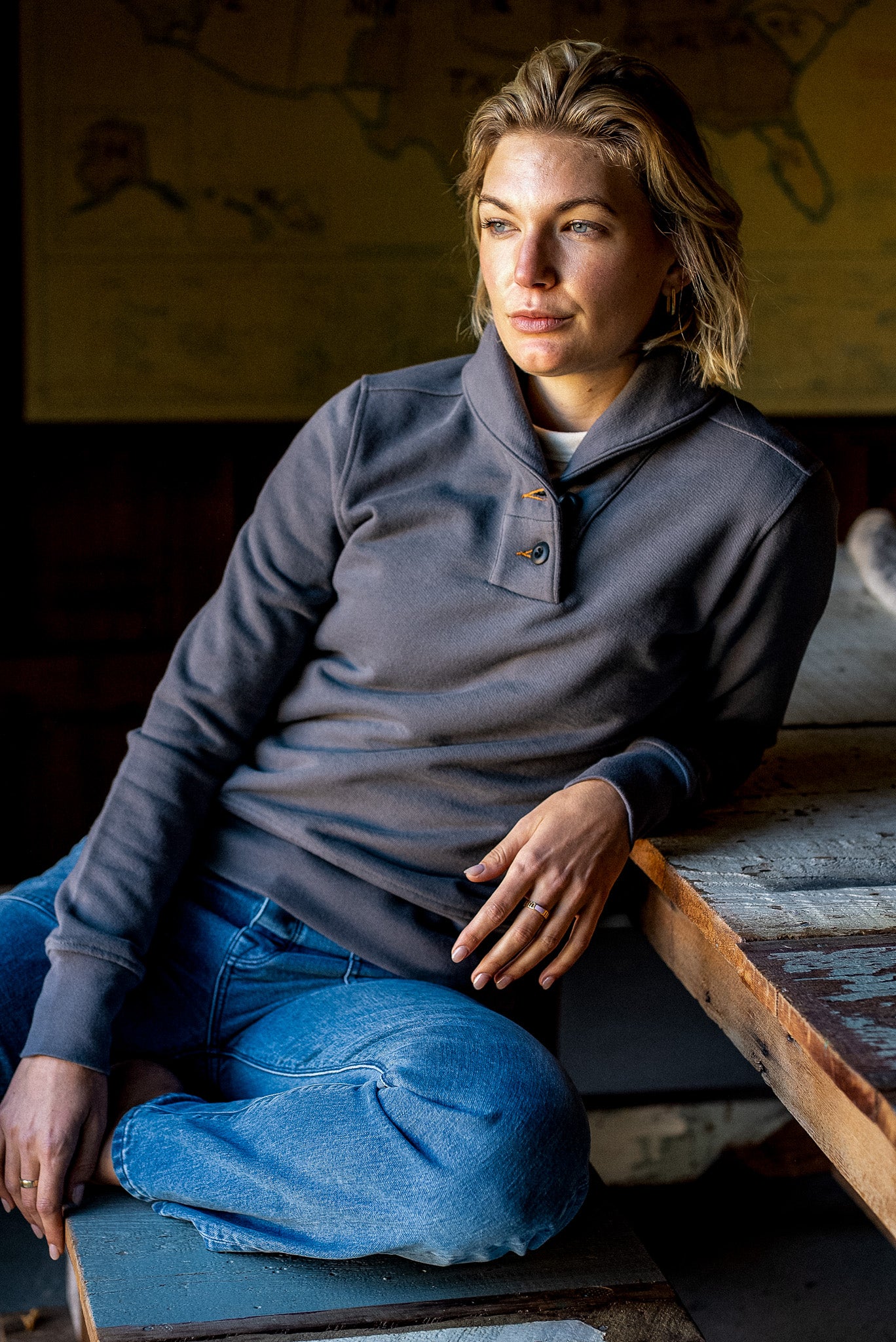 Pebble gray Bodega shawl-collar pullover worn on-model with jeans in a rustic cabin.