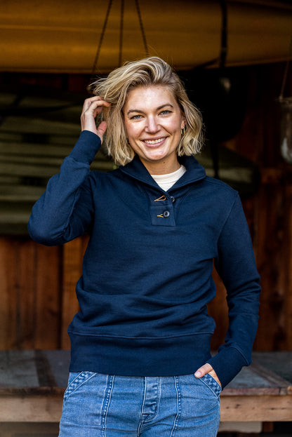 Woman wearing WiesMade navy shawl collar pullover with button placket, styled over jeans.