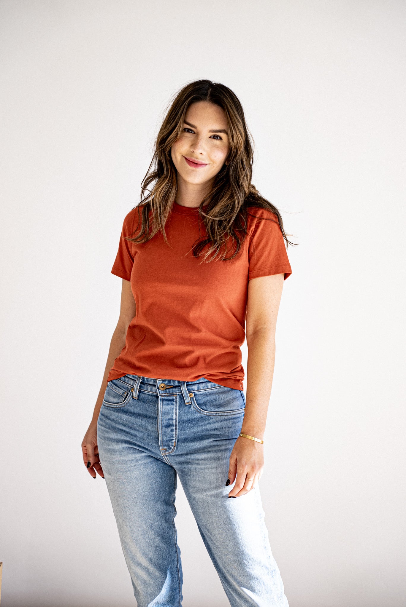 Women's Bolinas heavyweight tee in brick, styled with light-wash jeans against a white backdrop.