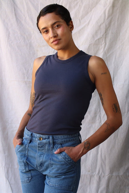 Model wearing the Bolinas cotton tank in polar navy, tucked into light-wash jeans.