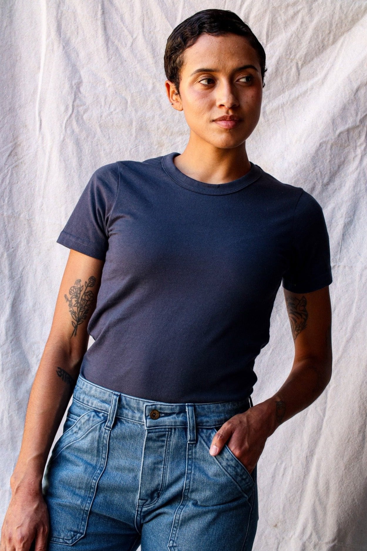 Model wearing the Bolinas heavyweight tee in polar dark blue-gray, paired with light wash jeans.