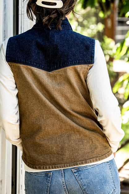 Back view of the Jamie wheat denim vest with contrasting indigo yoke, worn over a cream top.