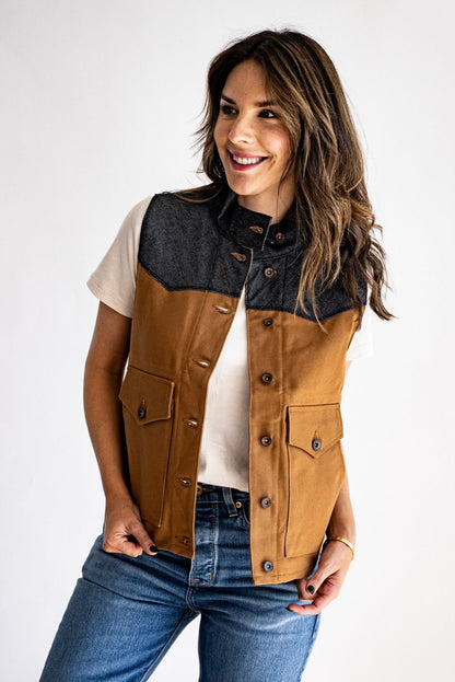 Jamie vest in tan canvas with raw denim yoke, worn over a cream tee with blue jeans.