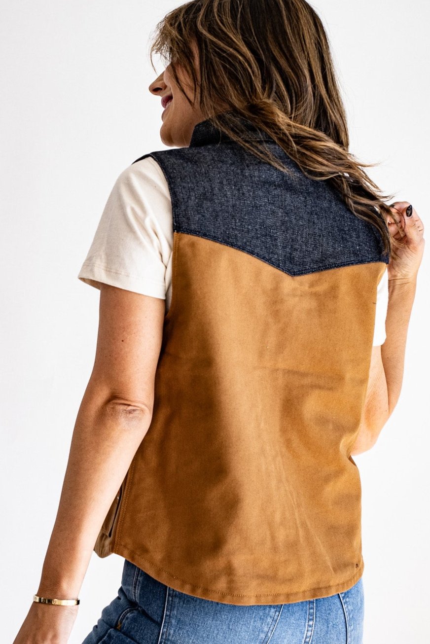 Back view of the Jamie vest showing tan canvas body with a denim yoke across the shoulders.