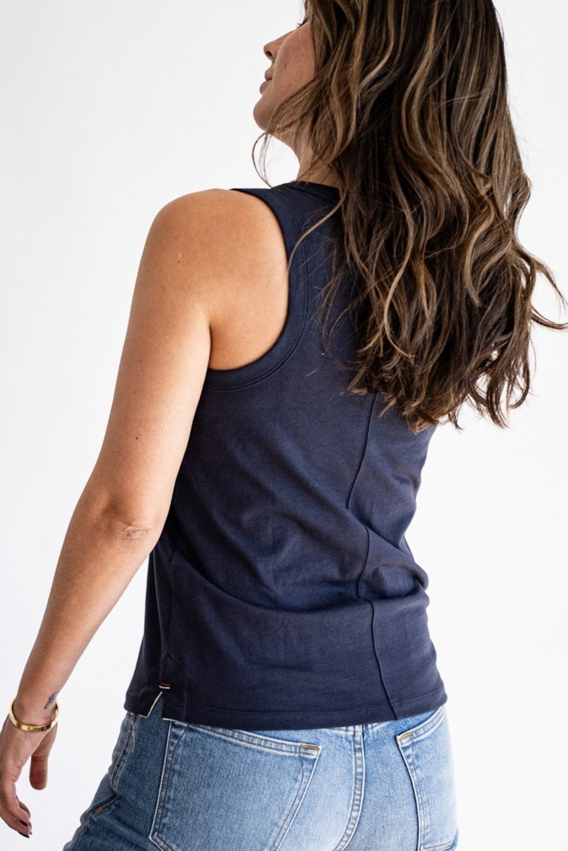Back view of the Reyes cotton tank in polar navy, paired with blue denim jeans.