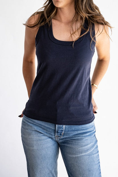 Navy scoop-neck cotton tank top styled with light wash denim jeans.