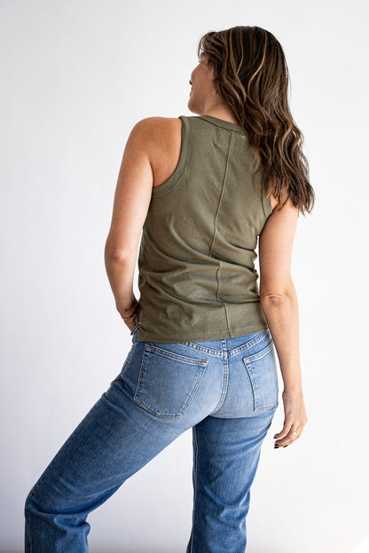 Back view of the olive cotton Reyes tank paired with light-wash denim jeans.