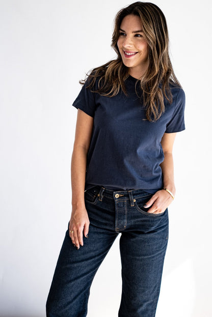Woman wearing the Reyes boxy tee in Polar navy with dark raw denim jeans.
