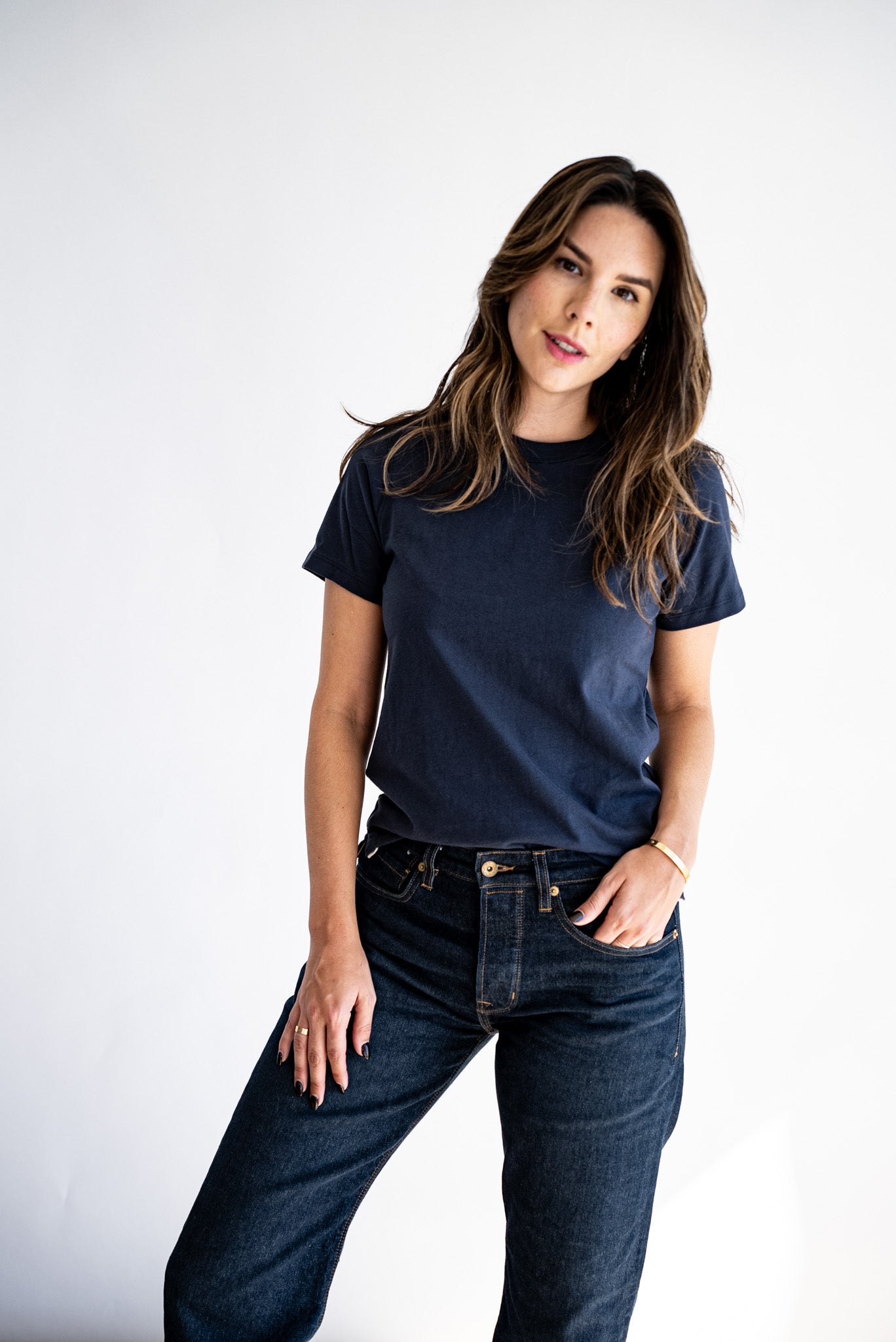 Model wearing the Reyes boxy tee in navy with dark raw denim jeans.