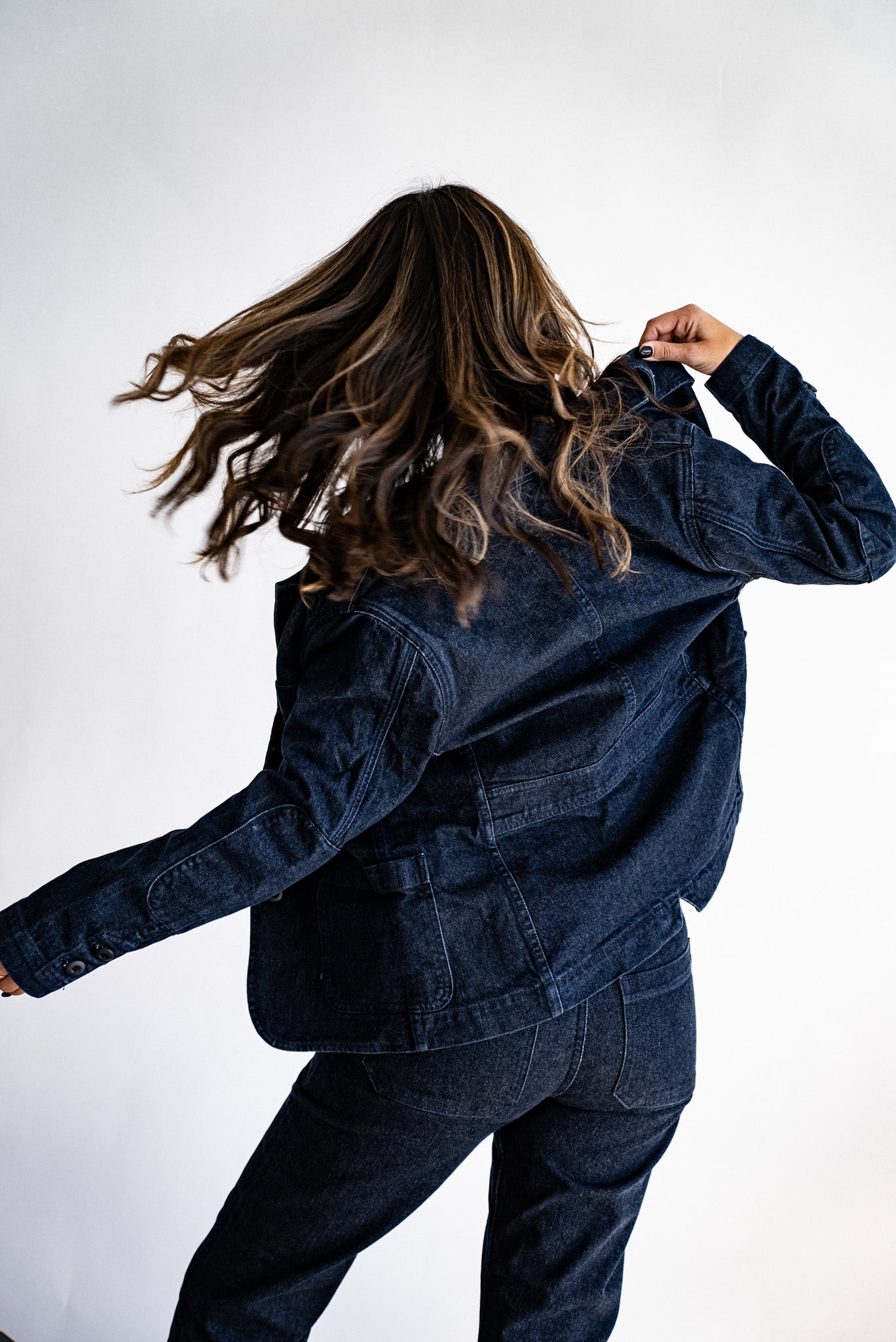 Back view of the ocean indigo Scout denim chore blazer with patch pockets and cuff buttons.