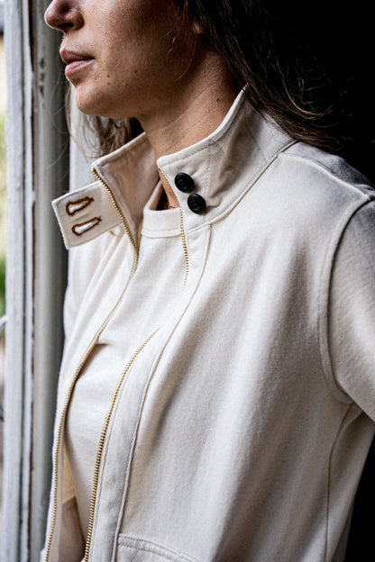 Close-up of natural cotton Stinson moto jacket collar with brass zipper and buttons.