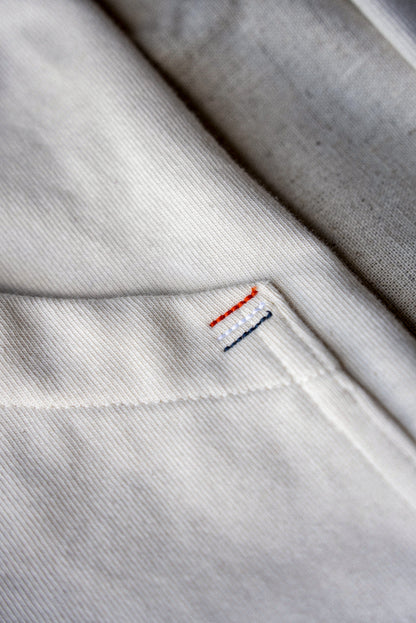 Contrast orange, white, and navy topstitching on natural cotton twill of the Stinson moto jacket.