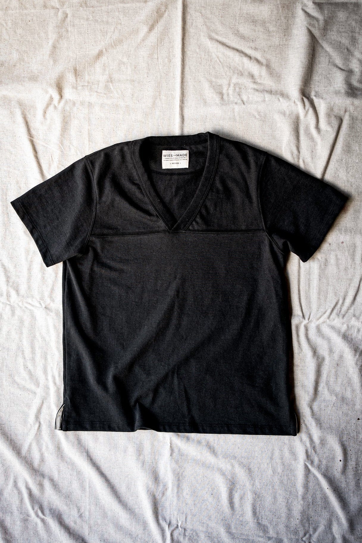Women's Stinson basalt V-neck jersey tee in 12oz cotton, laid flat on linen.