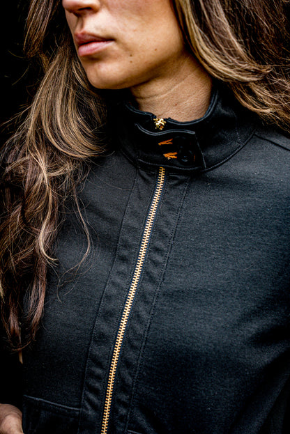 Detail of women's Stinson Moto cotton jacket in Basalt with brass zipper and stand collar.