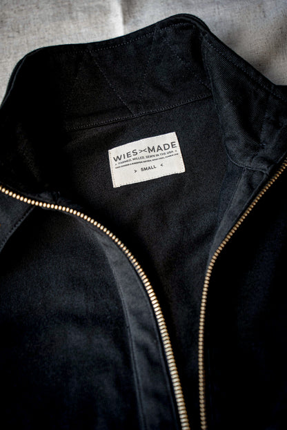 Close-up of black women's moto jacket collar with brass zipper and made-in-USA WiesMade label.