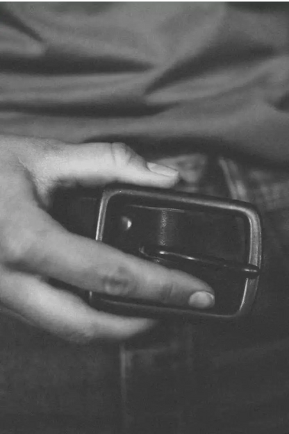 Latigo Belt made from 1.5” 8oz American Latigo leather, shown in a black & white filter with hand detail