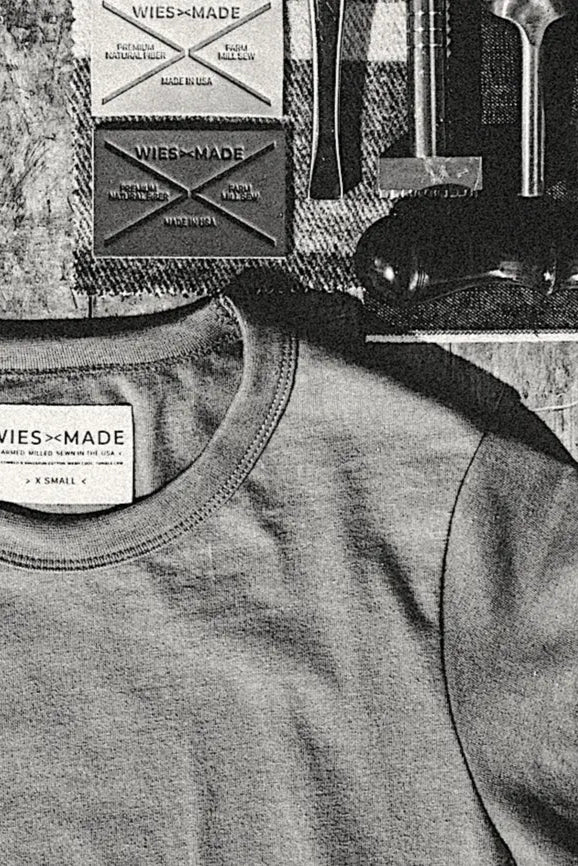 Close-up of the Reyes boxy tee neckline in natural cotton with WiesMade Made in USA label.
